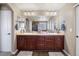Bathroom featuring a double sink vanity, large mirror, modern lighting, and a neutral color palette at 15753 E Indian Brook Cir, Parker, CO 80134