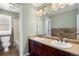 Bathroom featuring a double vanity, neutral counter, framed mirror, and modern lighting at 15753 E Indian Brook Cir, Parker, CO 80134
