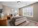 Cozy bedroom with neutral walls, plush carpet, decorative prints, and natural light from shuttered windows at 15753 E Indian Brook Cir, Parker, CO 80134