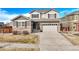 Beautiful two-story home with a two-car garage and stone accents with a well manicured lawn at 15753 E Indian Brook Cir, Parker, CO 80134