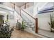 A bright foyer with tile floors and a staircase with beautiful, white railing at 15753 E Indian Brook Cir, Parker, CO 80134