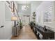 Bright foyer featuring a chandelier, tiled flooring, console table, and a well-lit staircase at 15753 E Indian Brook Cir, Parker, CO 80134