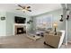Comfortable living room with fireplace, plush seating, and large windows for natural light at 15753 E Indian Brook Cir, Parker, CO 80134