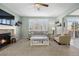 Inviting living room with fireplace, ceiling fan, and neutral tones at 15753 E Indian Brook Cir, Parker, CO 80134