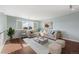 Cozy living room featuring a plush sectional and hardwood floors at 15753 E Indian Brook Cir, Parker, CO 80134