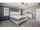 Large main bedroom featuring neutral carpet, ample light from window shutters, and a decorative headboard at 15753 E Indian Brook Cir, Parker, CO 80134