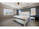 Spacious main bedroom with a ceiling fan, tray ceilings, shutters on the windows, and an accent wall at 15753 E Indian Brook Cir, Parker, CO 80134