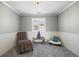 Sitting room with wainscotting, plush carpet, neutral walls, shuttered windows, and comfortable seating at 15753 E Indian Brook Cir, Parker, CO 80134