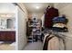 Walk-in closet with ample shelving, hanging space, and convenient access to an adjacent bathroom at 15753 E Indian Brook Cir, Parker, CO 80134