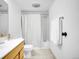 Bathroom featuring a white sink, toilet, tub, and white and gray shower curtain at 9700 E Iliff Ave # D44, Denver, CO 80231