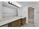 Well-lit bathroom featuring a vanity with tile countertop and a large mirror with bright vanity lighting at 9700 E Iliff Ave # D44, Denver, CO 80231