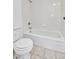 Compact bathroom with a standard toilet, and fully tiled bathtub and shower area for a clean and functional space at 9700 E Iliff Ave # D44, Denver, CO 80231