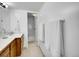 This bathroom features tile flooring, a white sink, and a bathtub with white tiling and towel racks at 9700 E Iliff Ave # D44, Denver, CO 80231