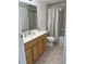Functional bathroom featuring single sink vanity, a toilet, and a shower tub with neutral-patterned curtain at 9700 E Iliff Ave # D44, Denver, CO 80231