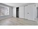 Bright bedroom with light hardwood floors, a large window, and a closet with large sliding doors at 9700 E Iliff Ave # D44, Denver, CO 80231
