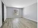 Bright bedroom featuring wood style flooring, a large window, and a spacious closet at 9700 E Iliff Ave # D44, Denver, CO 80231