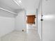 Tiled hallway features a coat closet and access to the living space with wood paneling at 9700 E Iliff Ave # D44, Denver, CO 80231