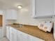 Bright kitchen features white cabinets, double sink, and cookbook on counter at 9700 E Iliff Ave # D44, Denver, CO 80231