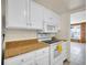 Kitchen boasts white appliances, white cabinets, and neutral countertops at 9700 E Iliff Ave # D44, Denver, CO 80231