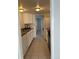 Galley style kitchen with white cabinets, laminate countertops, and appliances at 9700 E Iliff Ave # D44, Denver, CO 80231