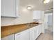 Bright kitchen features white cabinetry, double sink, and neutral countertops at 9700 E Iliff Ave # D44, Denver, CO 80231