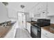 Galley-style kitchen features white cabinets, laminate countertops, and stainless steel appliances at 9700 E Iliff Ave # D44, Denver, CO 80231