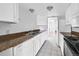 Traditional galley kitchen with tile flooring, a double sink, and white cabinetry at 9700 E Iliff Ave # D44, Denver, CO 80231