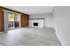 Spacious living room featuring wood accent wall, fireplace, and sliding doors to outdoor balcony at 9700 E Iliff Ave # D44, Denver, CO 80231