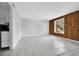 Open-concept living room with wood-paneled accent wall and large window for natural light at 9700 E Iliff Ave # D44, Denver, CO 80231