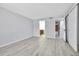 Bright, open living room with light hardwood flooring, access to bathroom and closet create a modern feel at 9700 E Iliff Ave # D44, Denver, CO 80231