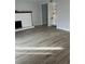 Bright and airy living room featuring fireplace, built in shelving and modern wood flooring at 9700 E Iliff Ave # D44, Denver, CO 80231