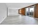 Bright living room boasts wood paneling, sliding glass door, and tiled entryway at 9700 E Iliff Ave # D44, Denver, CO 80231