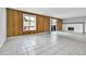 Living room with wood accent wall, fireplace, and sliding door provides abundant natural light at 9700 E Iliff Ave # D44, Denver, CO 80231