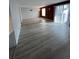 Open concept living room featuring new flooring, wood paneled walls, and sliding doors to outdoor balcony at 9700 E Iliff Ave # D44, Denver, CO 80231