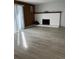 Living room features fireplace, wood accent paneling and a sliding glass door at 9700 E Iliff Ave # D44, Denver, CO 80231