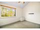 Bright bedroom featuring a large window letting in natural light and a built-in storage bench at 718 Julian Cir, Lafayette, CO 80026