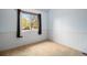 Cozy bedroom with a large window, neutral carpet, and wainscoting at 718 Julian Cir, Lafayette, CO 80026