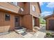 Charming townhome featuring brown wood siding, a welcoming front door, and a well-maintained walkway at 718 Julian Cir, Lafayette, CO 80026