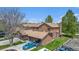 Aerial view of a townhome with garages and landscaped surroundings under a clear blue sky at 718 Julian Cir, Lafayette, CO 80026