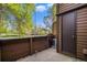 A quaint patio with a wooden privacy fence and access to the home's exterior at 718 Julian Cir, Lafayette, CO 80026