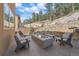 Beautiful backyard with a fire pit, outdoor seating, and wooded views for entertaining at 756 Dreamcatcher Ln, Evergreen, CO 80439