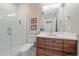 Bathroom featuring a modern vanity, a shower with glass doors and contemporary fixtures at 756 Dreamcatcher Ln, Evergreen, CO 80439