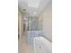 Bright bathroom featuring modern soaking tub and walk-in shower with custom herringbone tile at 756 Dreamcatcher Ln, Evergreen, CO 80439