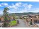 Beautiful view of community street featuring well-maintained homes, landscaping, and mountain views in the background at 756 Dreamcatcher Ln, Evergreen, CO 80439