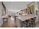 Spacious kitchen with island seating, stainless steel appliances, open floor plan, and hardwood floors leading to the living area at 756 Dreamcatcher Ln, Evergreen, CO 80439