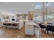 Open concept kitchen with stainless steel appliances, island seating, hardwood floors, and adjacent dining area at 756 Dreamcatcher Ln, Evergreen, CO 80439