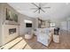 Open living room with fireplace, hardwood floors, and a seamless transition to the modern kitchen at 756 Dreamcatcher Ln, Evergreen, CO 80439