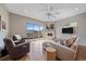 Comfortable living room with hardwood floors, fireplace, balcony, and large windows providing natural light and mountain views at 756 Dreamcatcher Ln, Evergreen, CO 80439