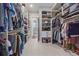 Large walk-in closet with extensive shelving and hanging storage for clothes and accessories at 756 Dreamcatcher Ln, Evergreen, CO 80439