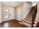 Bright entryway with hardwood floors, a white front door, and staircase with wrought iron spindles at 10618 Soulmark Way, Highlands Ranch, CO 80126